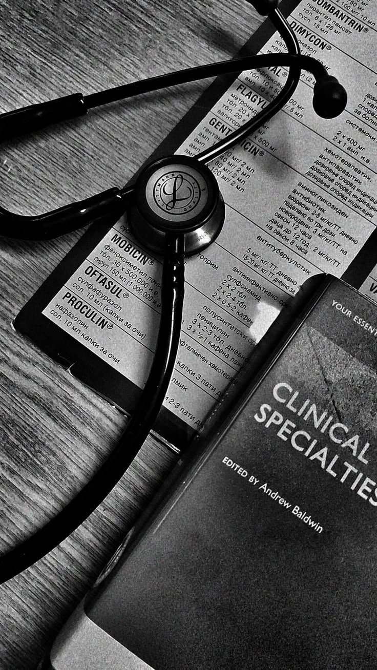Stethoscope and clinical reference materials on a desk